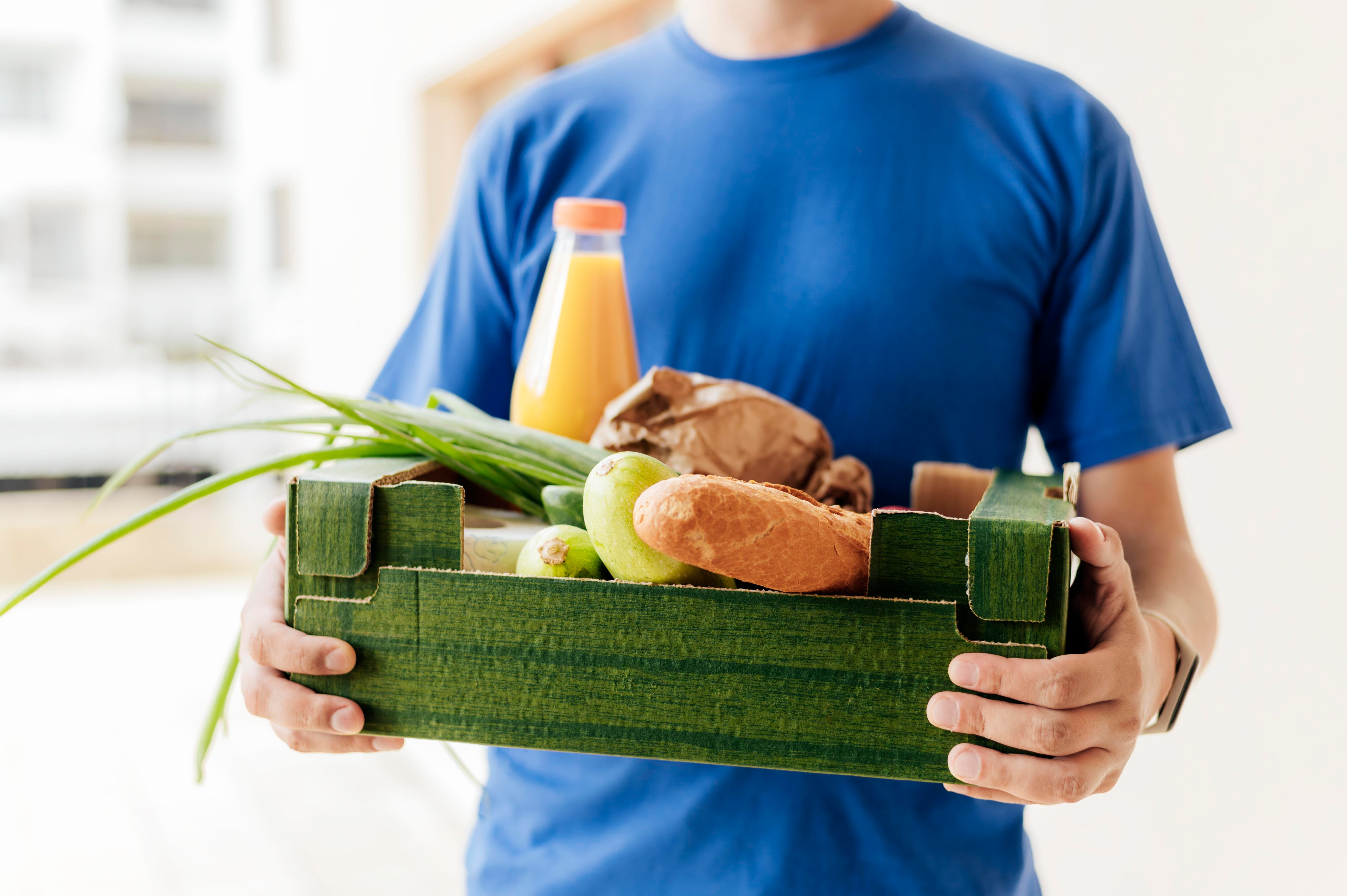 close-up-man-holding-food-crate