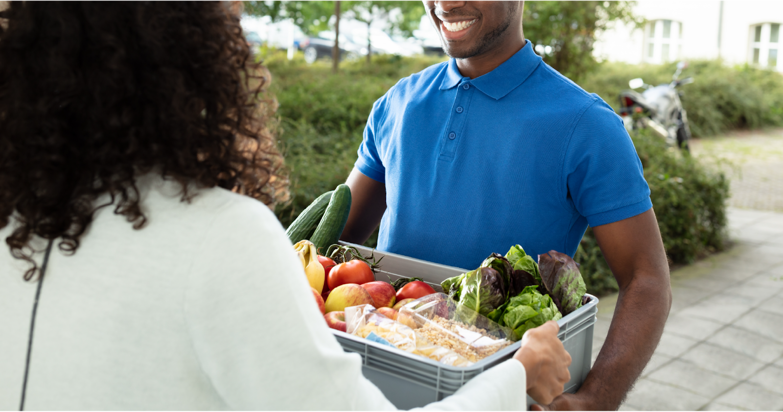 A smiling Stuart courier delivering groceries