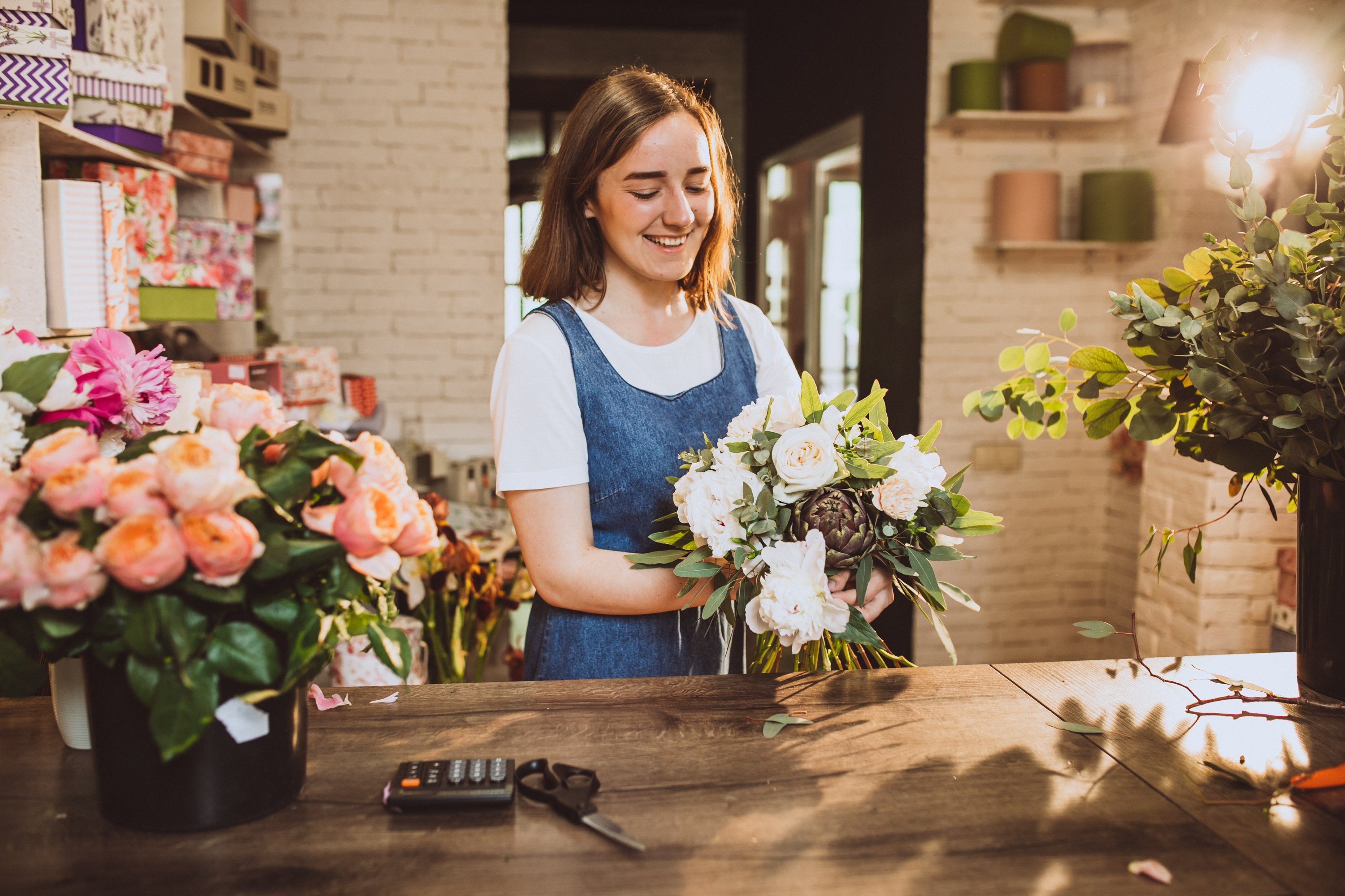 woman-florist-her-own-floral-shop-taking-care-flowers